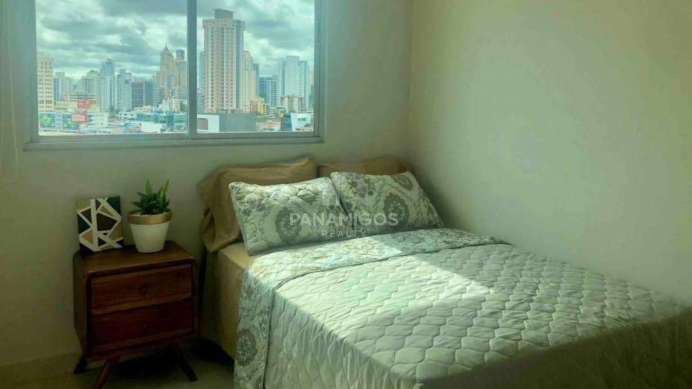 Spacious bedroom with city view window, bright natural light in PH Oasis Via Porras Panama City