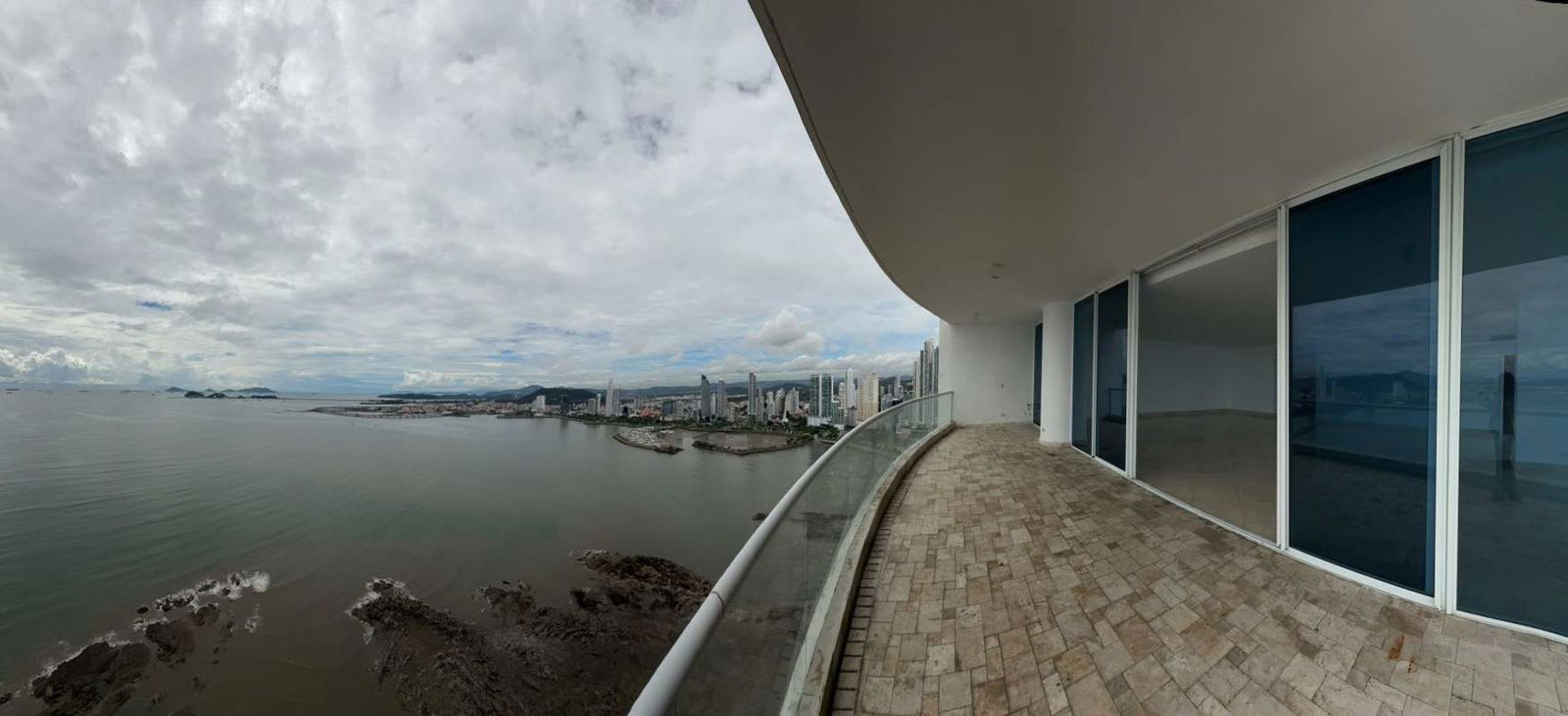 Large bedroom featuring marble floors, built-in wardrobe, skyline view at PH The Point Panama