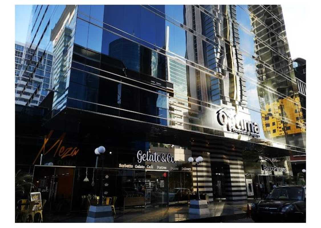 Exterior view of Torre Optima commercial tower with reflective glass facade in Obarrio Panama City