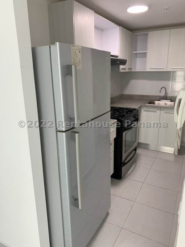 Compact functional kitchen with light gray cabinets and appliances