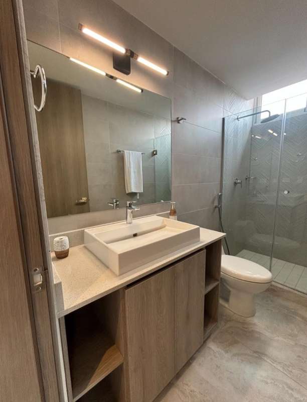 Modern bathroom with vessel sink glass shower and wood vanity PH Pacific Midtown El Cangrejo Panama