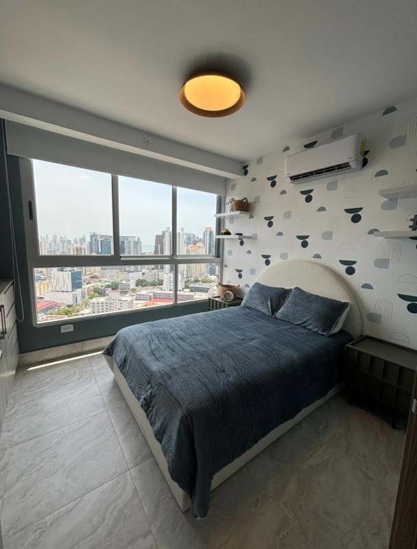 Bedroom with panoramic windows city view and accent wall in PH Pacific Midtown El Cangrejo Panama