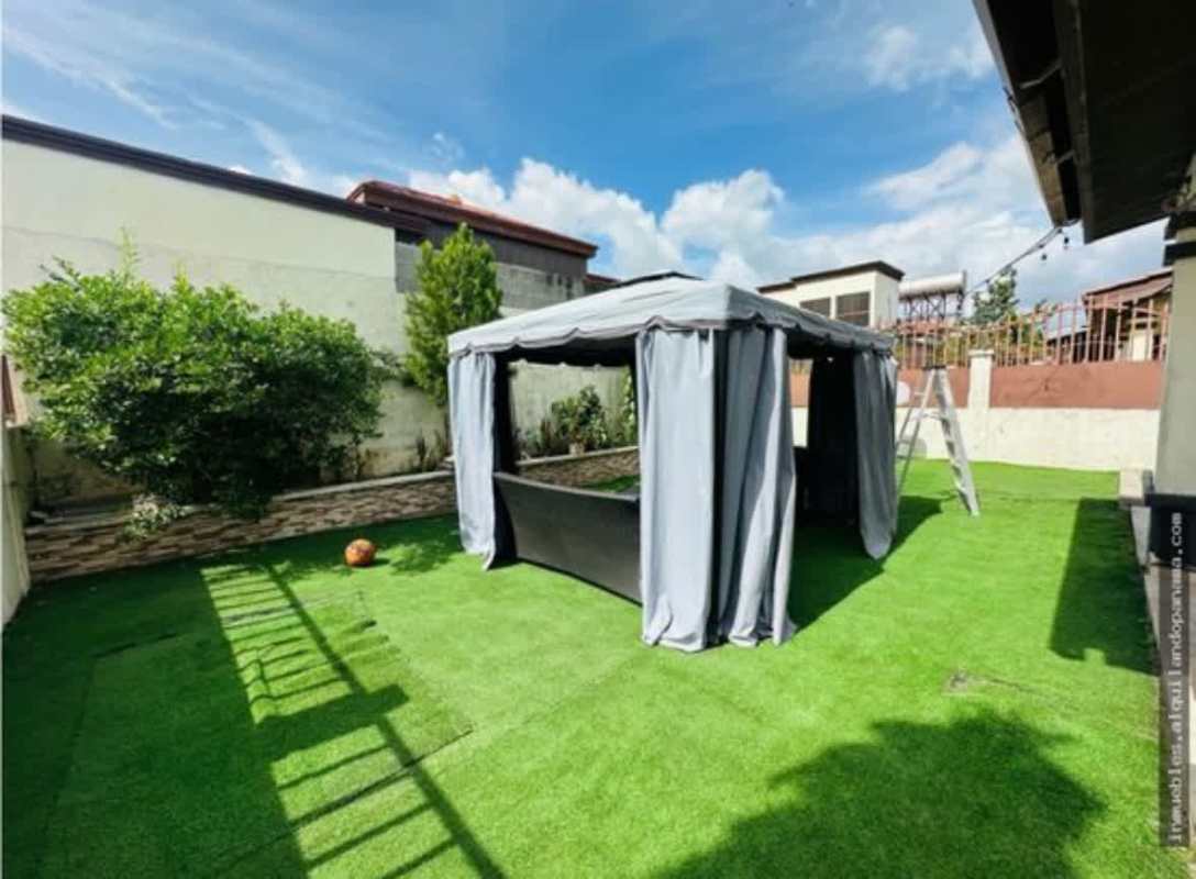 Private backyard with artificial grass and gazebo for entertaining in Mirador del Lago Las Cumbres Panama