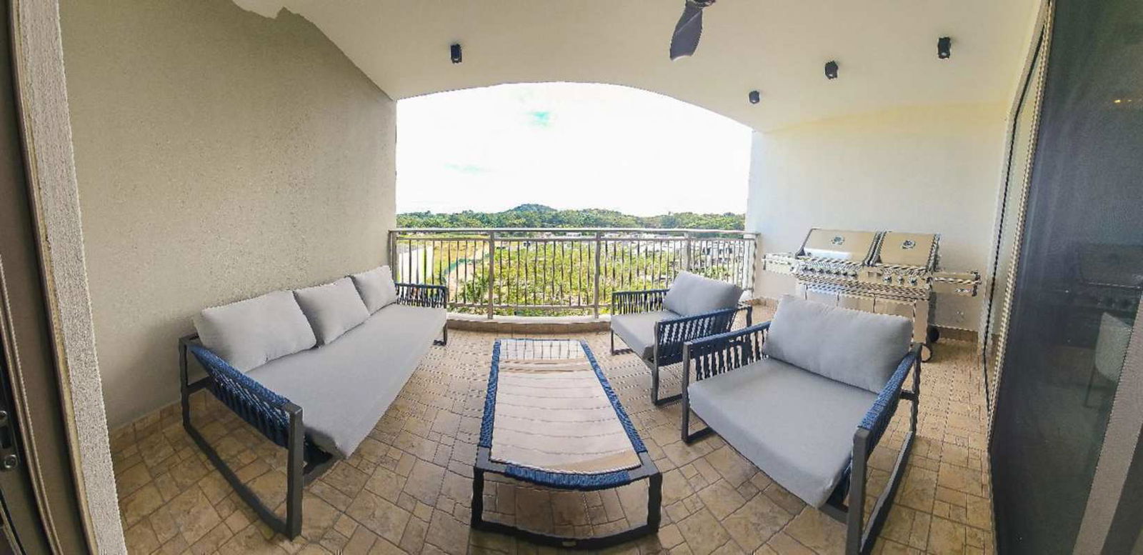 Open plan dining with floor-to-ceiling windows overlooking ocean at PH Ocean Club Panama City