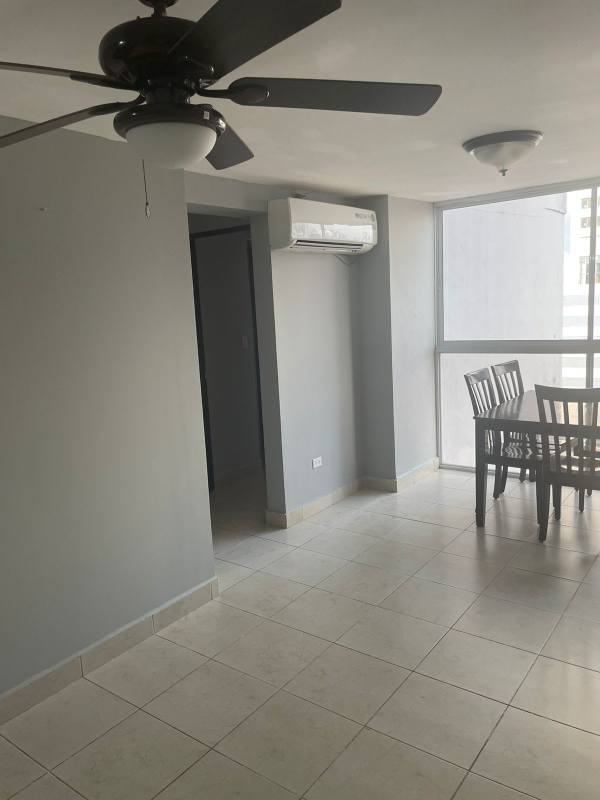 Dining space features ceramic tile floor, AC, large windows with urban views in apartment for sale in Panama