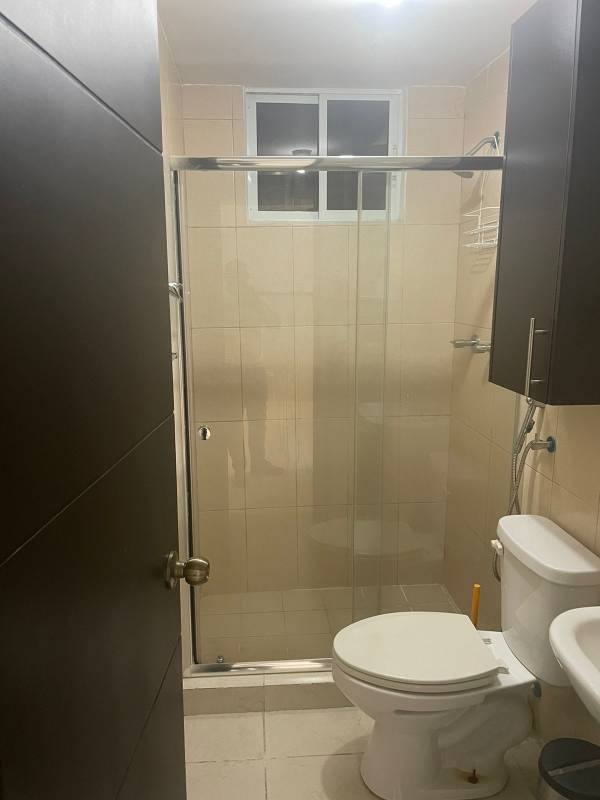 Contemporary bathroom with glass shower enclosure, ceramic tile walls in Panama apartment sale