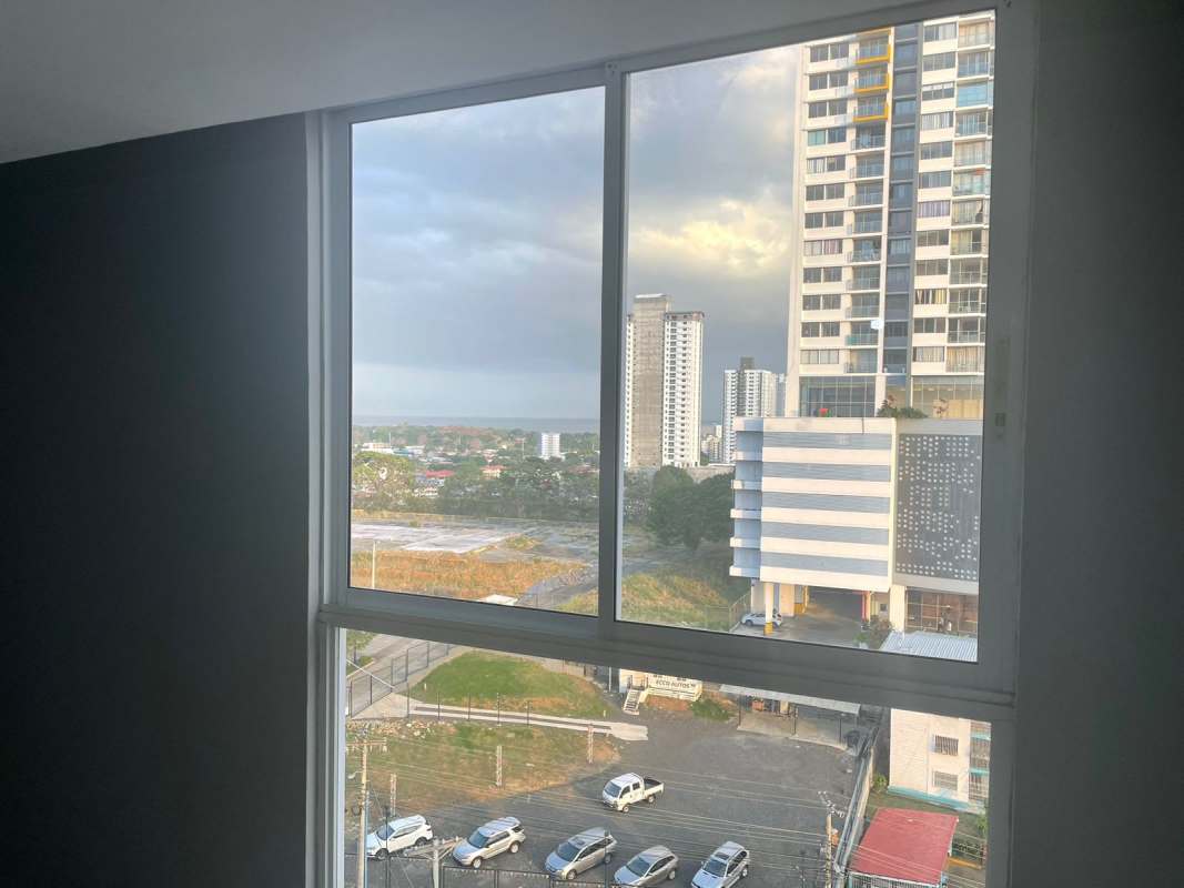 Bedroom features black wardrobe, neutral walls, AC unit PH Vista Marina Towers Panama apartment sale