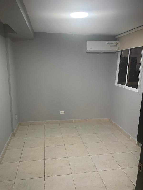 Modern bedroom with ceramic floor, natural light, AC and built-in closet in Panama City apartment for sale