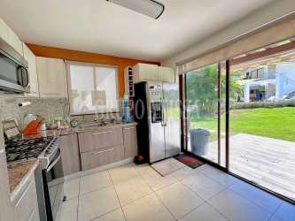 Modern bathroom with walk-in shower, beige tiles and glass enclosure in Rio Mar house