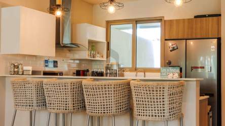 Open concept kitchen with breakfast bar stainless appliances Playa Escondida Villa Panama