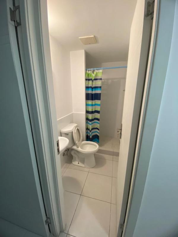 Compact bathroom with walk-in shower and pedestal sink PH ILO Panama