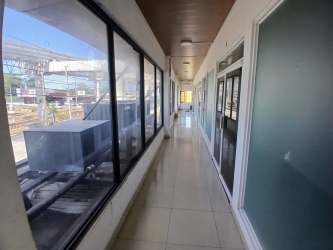 Tiled stairwell with steel handrails and emergency exit signs in commercial property Vista Alegre Panama