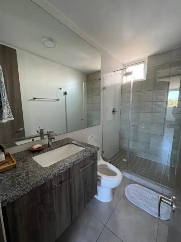 Galley kitchen with granite counters and laundry appliances in PH Brisas Tower Panama