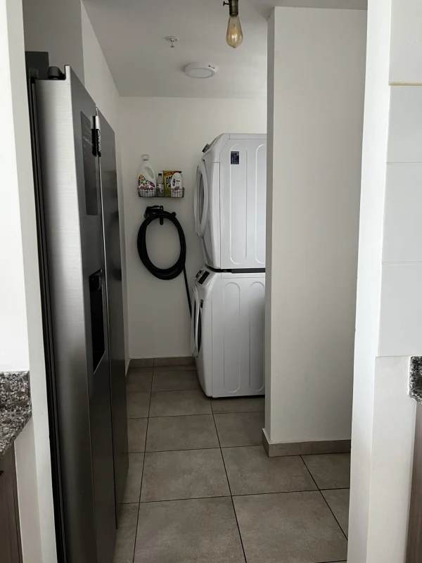 Laundry area with washer hook-up and storage shelves in Brisas Tower apartment Panama