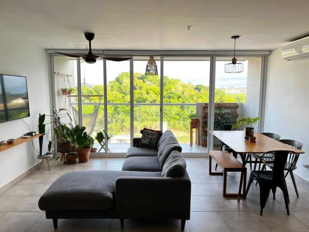 Apartment kitchen in Brisas Tower with granite countertops, pendant lights, and open shelving Panama City