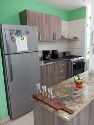 Living dining with mounted TV, green wall paint, ceramic tiles at Terrazas del Oeste La Chorrera