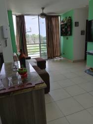 Living space with large windows, green accents, bright tile floors in Terrazas del Oeste La Chorrera