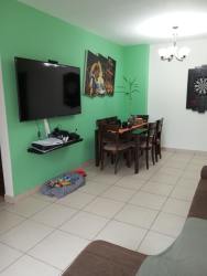 Contemporary living dining space with green walls, mounted TV, ceramic floors at PH Terrazas del Oeste La Chorrera