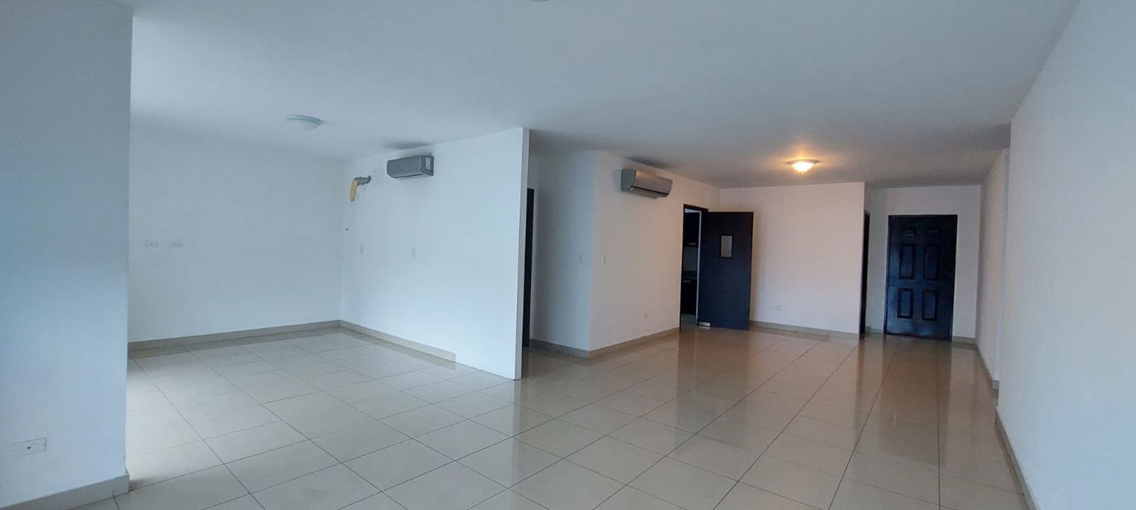 Bright living space with floor-to-ceiling windows and balcony access at PH Waterfalls Panama