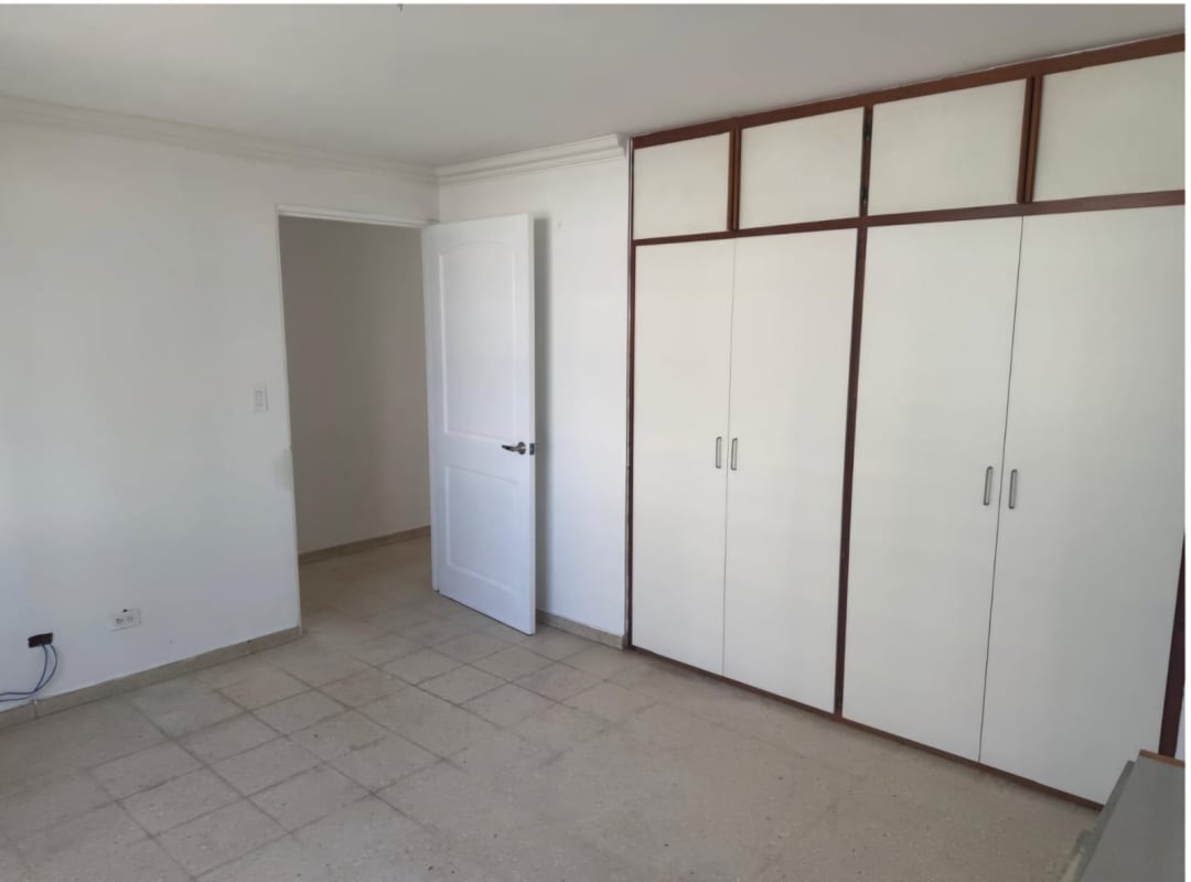 Empty bedroom with tile floor large wardrobe white walls in PH Marfil Obarrio Panama City