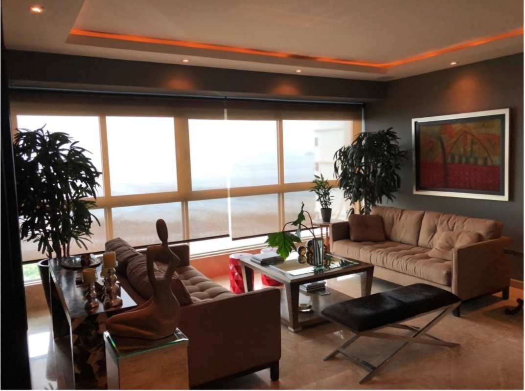 Living room with large windows offering ocean and skyline view, stylish furniture PH Torre Zeus Panama
