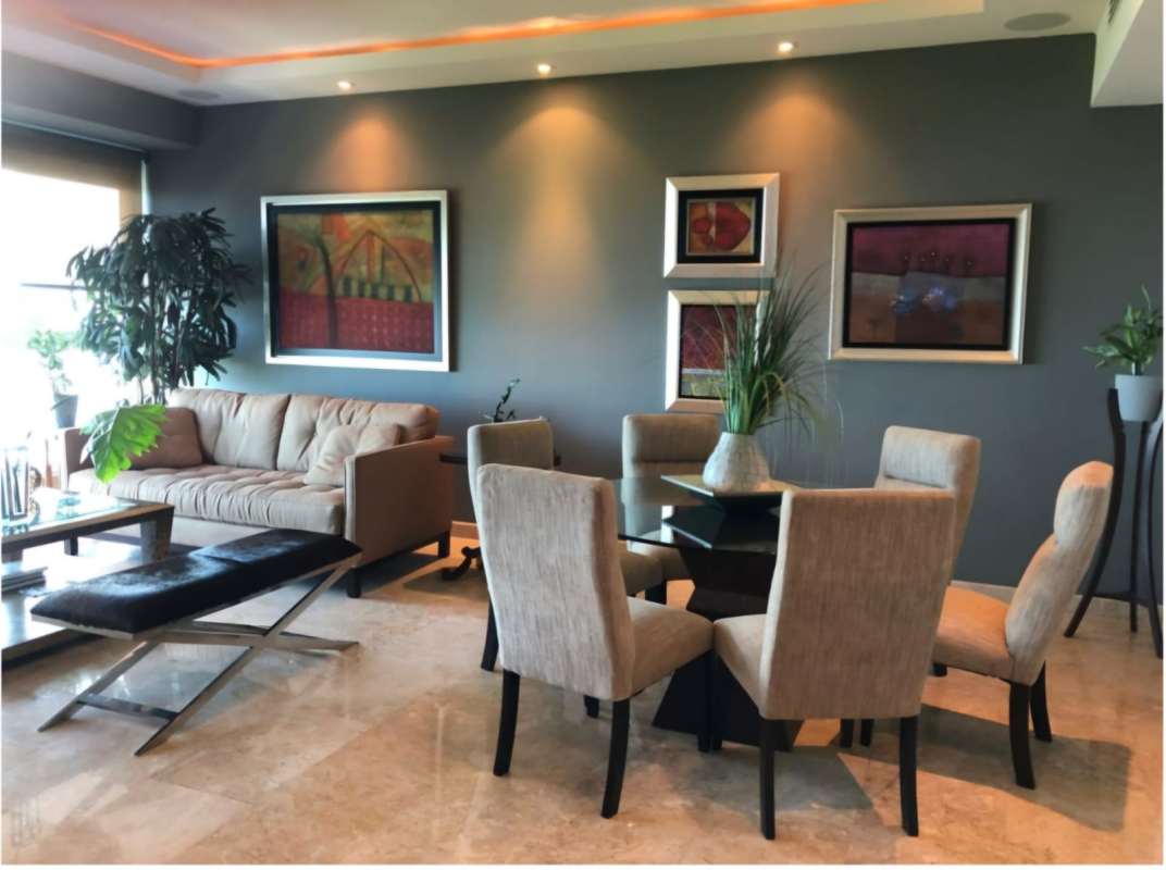 Combined living dining area with marble floors, elegant design, panoramic windows at PH Torre Zeus Costa del Este Panama