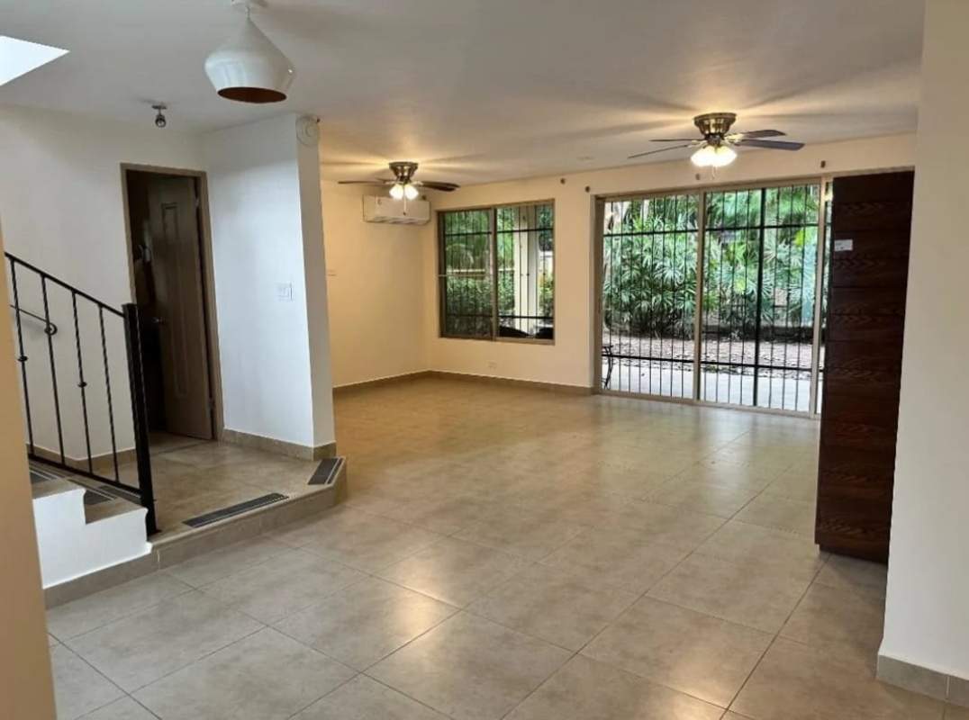 Bright living room with tile floors large windows garden view in Embassy Gardens Clayton Panama
