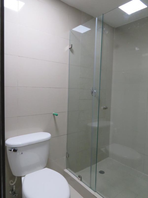 Contemporary bathroom vanity, mirror with mosaic frame, modern sink and shower in Tumba Muerto apartment Panama