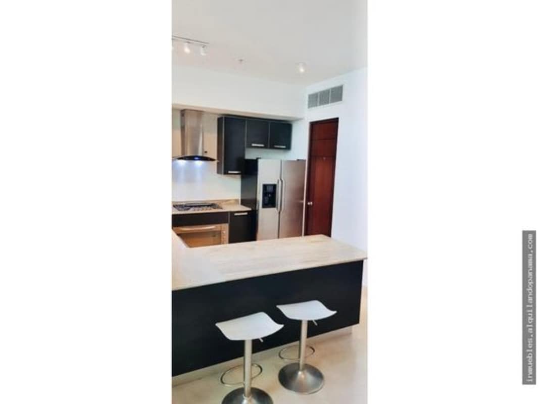 Contemporary kitchen with bar seating, stainless appliances in PH Pacific Village Punta Pacifica Panama
