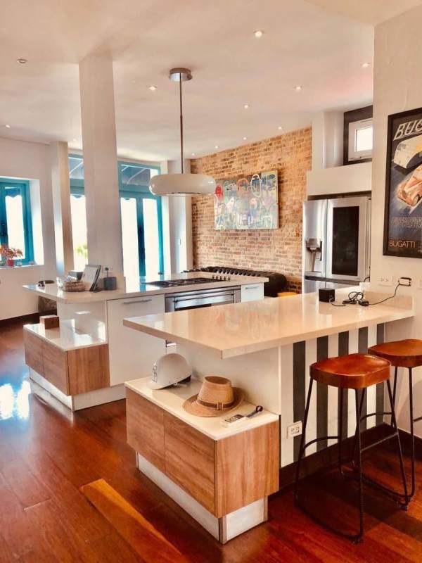 Contemporary kitchen with island and exposed brick accent wall Casco Viejo Panama