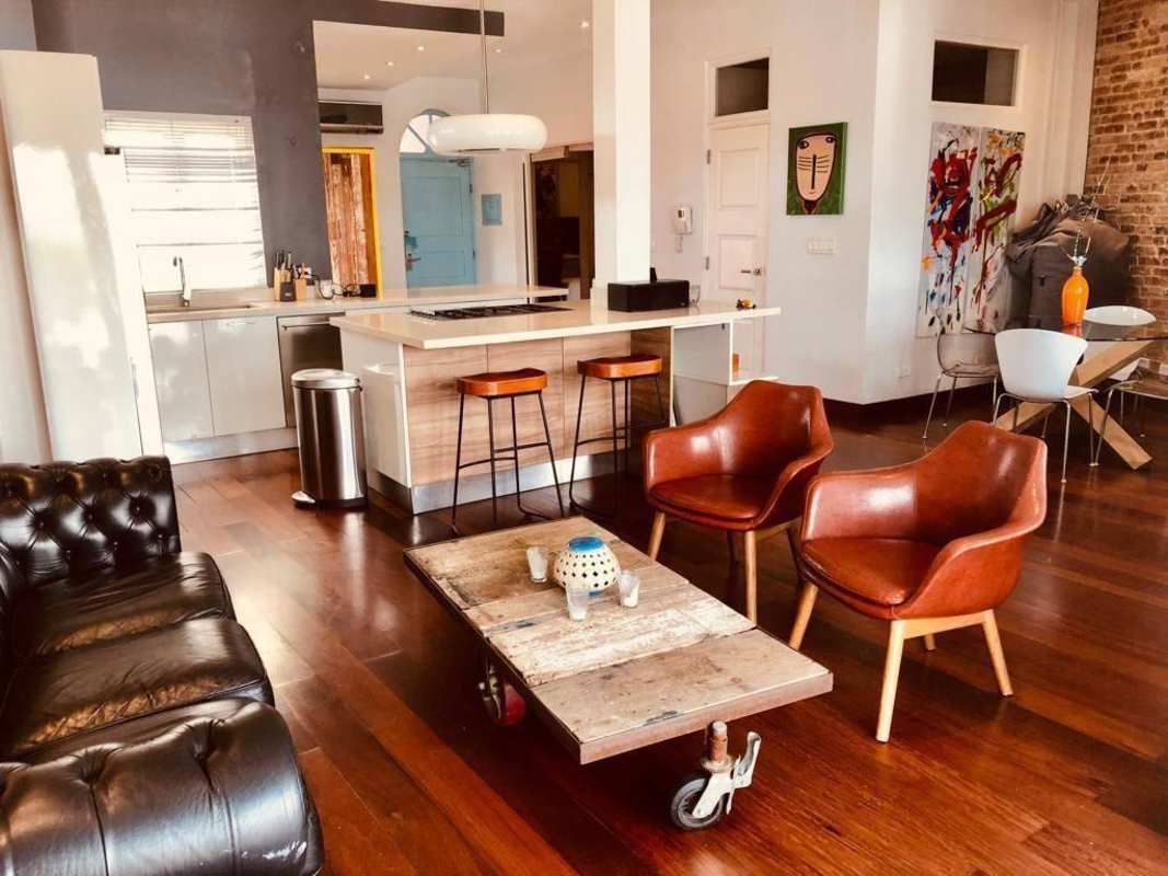 Spacious open-plan living and kitchen area with exposed brick wall in Casco Viejo Panama