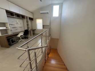 Modern kitchen with island bar stools stainless steel appliances in Casamar beachfront duplex for sale Panama