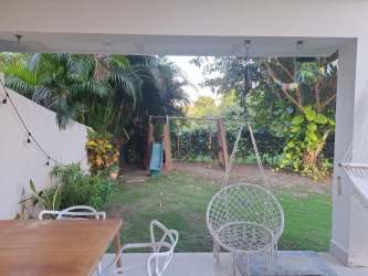 Master bedroom with large glass doors garden view duplex house Casamar Panama for sale