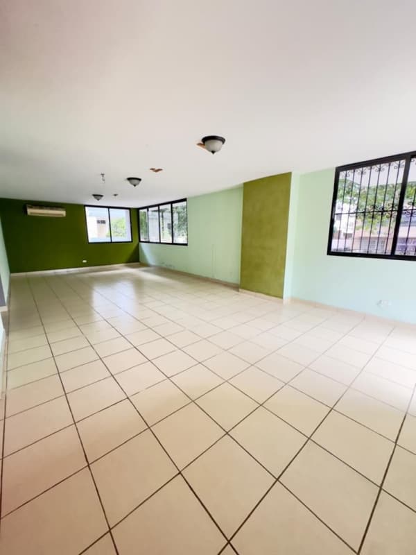 Large open living room with tile flooring and big windows in PH El Carmen Panama