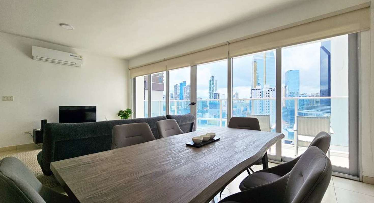 Bright living dining space with floor-to-ceiling windows and ocean view Avenida Balboa Panama