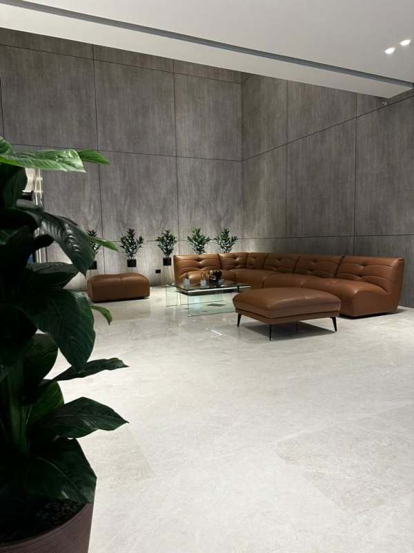 Open modern living room with leather sectional sofa in CenterPoint Tower