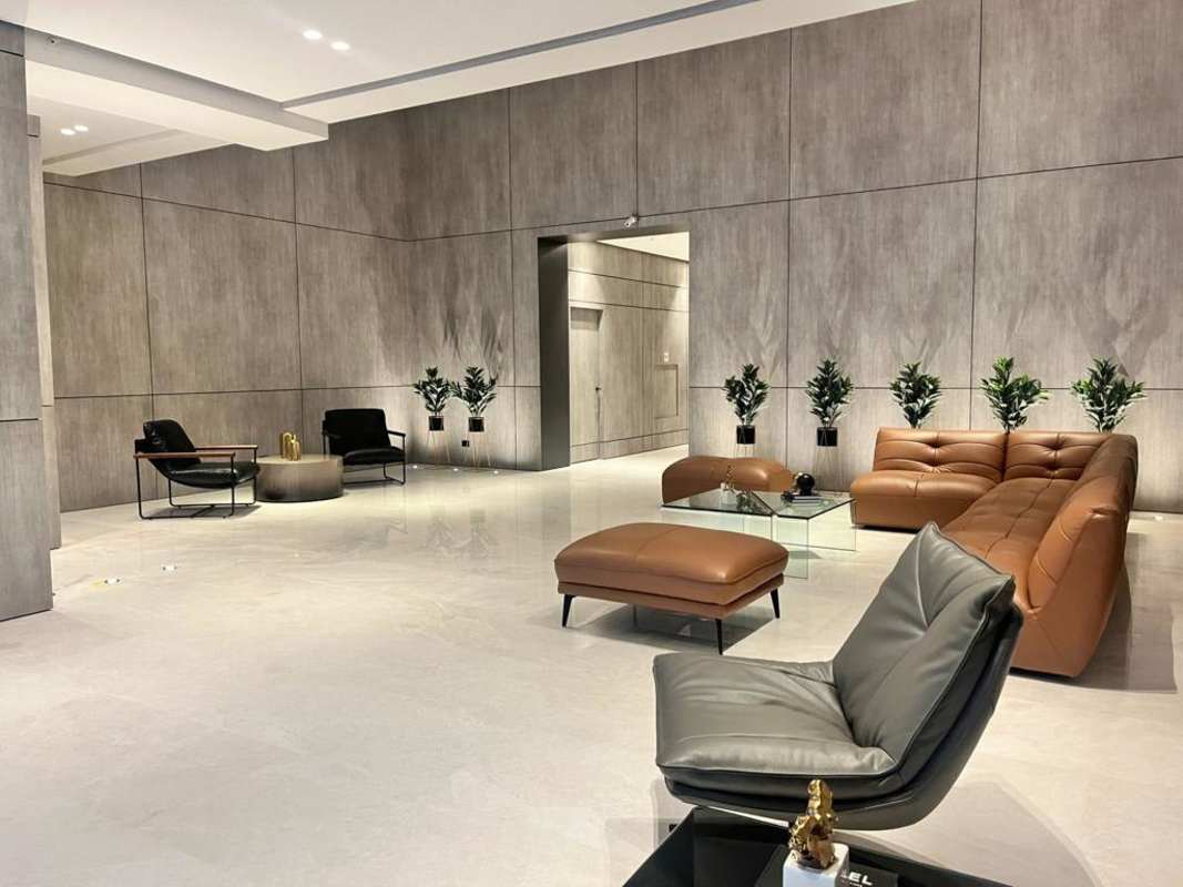 Modern living room with leather sofa, marble floors, and city skyline views in CenterPoint Tower Panama