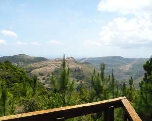 Wooden deck terrace overlooking green mountain landscape at Altos del María Panama