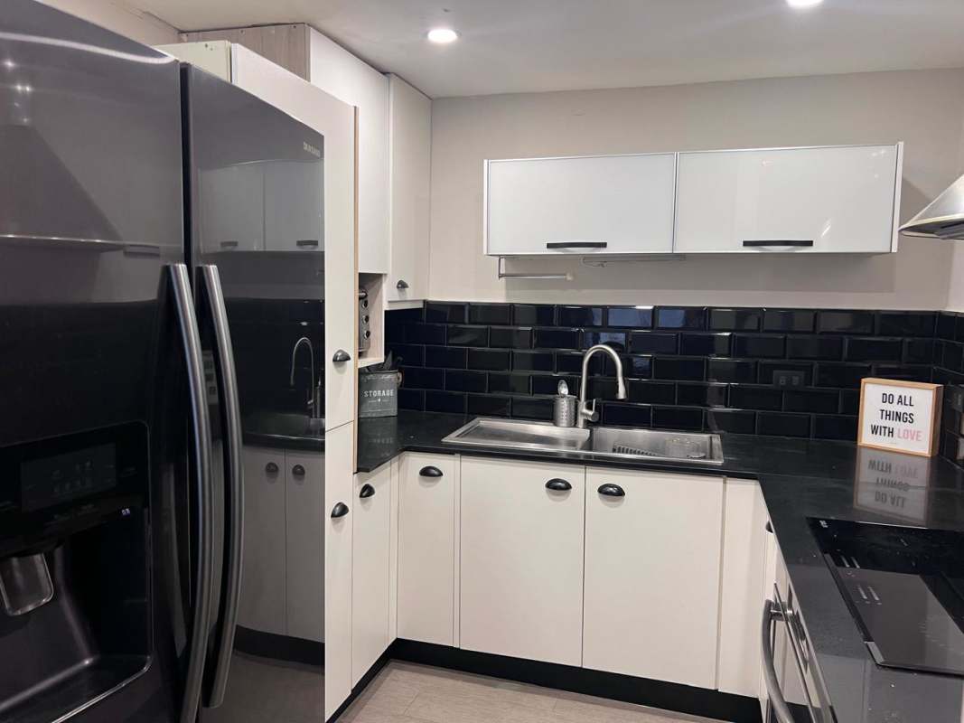 Spacious living room with sliding glass doors opening to pool area Diablo Heights Panama City