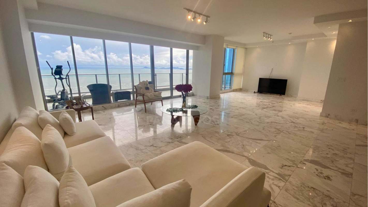 Elegant master bedroom suite with floor-to-ceiling windows and Pacific Ocean views in Costa del Este