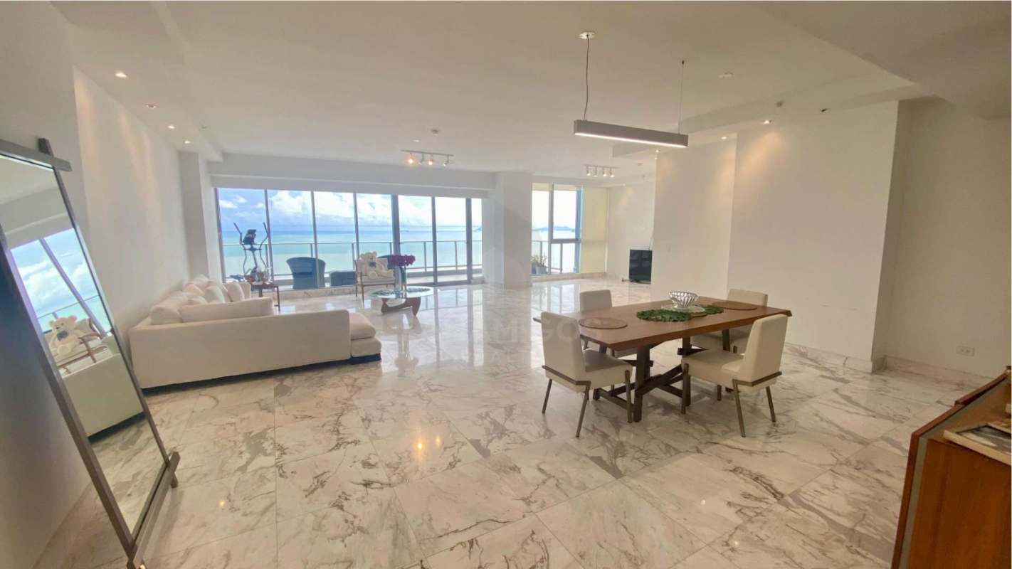 Dining space with panoramic windows overlooking Costa del Este skyline and Pacific Ocean in PH Regalia apartment