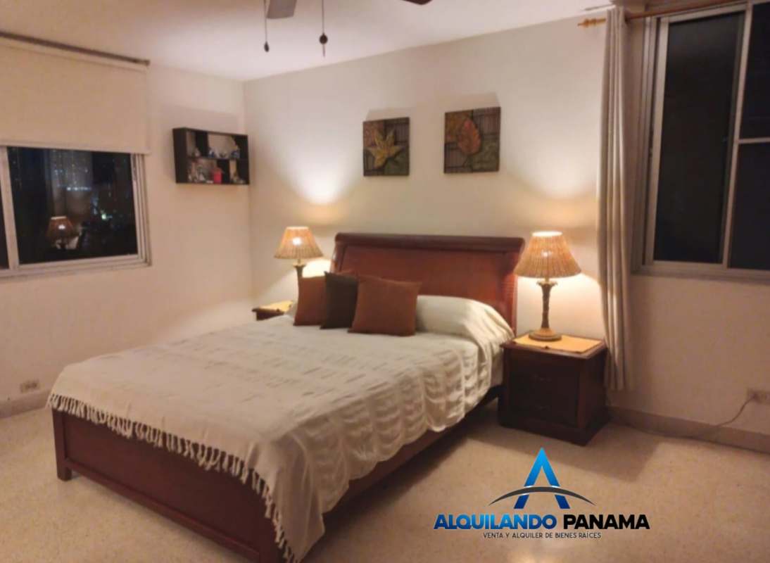 Bedroom featuring large window, neutral tones and cozy setting in PH El Carmen Panama