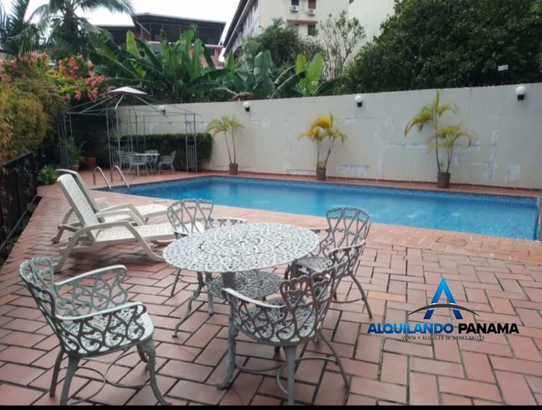 Swimming pool with tile deck and lounge area at PH El Carmen Panama City