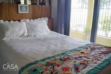 Reading nook in beach house living room with bookshelf and natural light