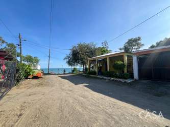 Cozy bedroom with big windows and wood bed Puerto Armuelles beachfront