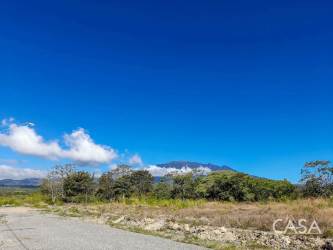 Vacant 2,600m² land lot along main Boquete highway with clear skies and rural surroundings