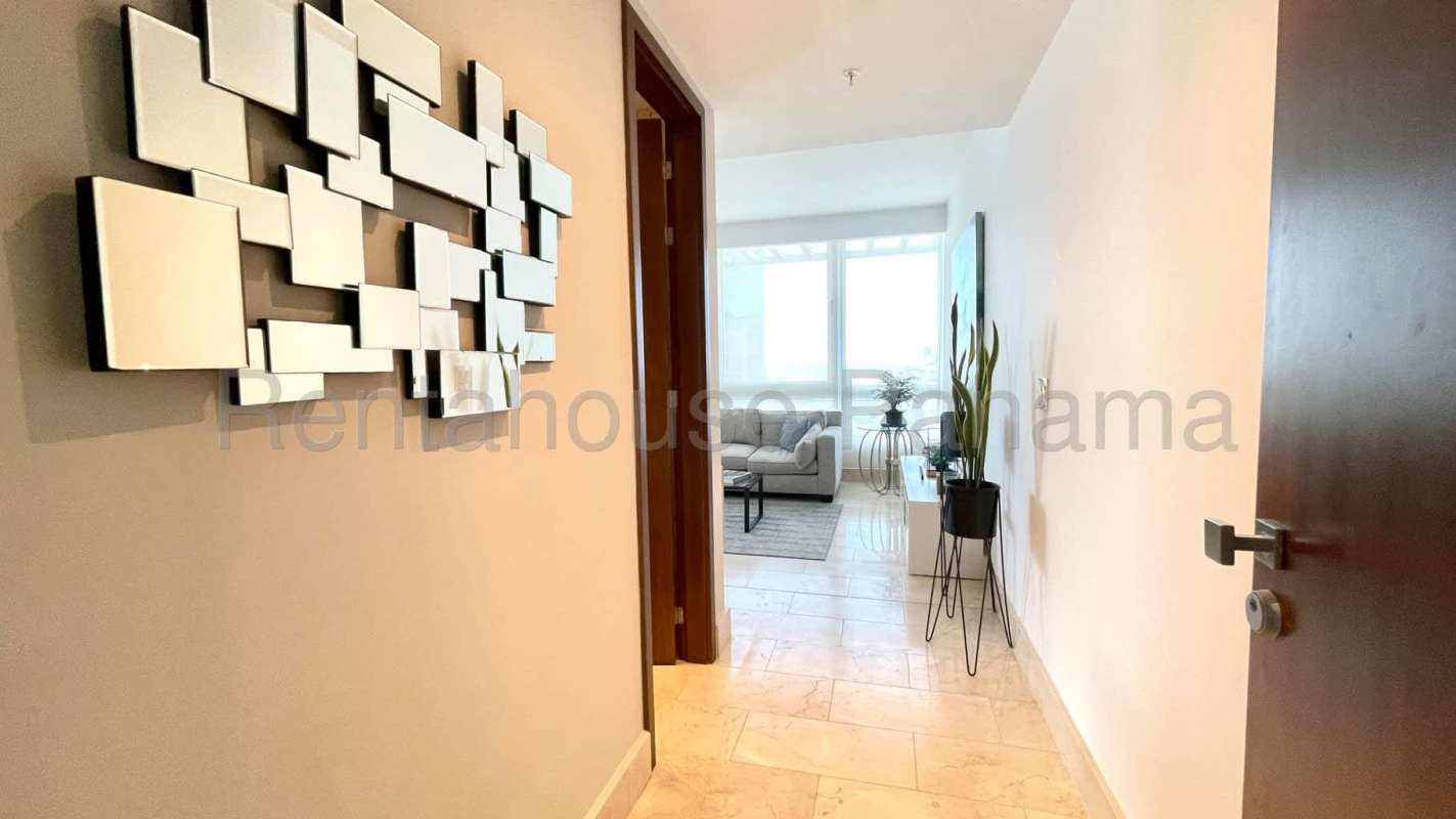 Modern gourmet kitchen with marble floors and center island at Coco del Mar Tower Panama