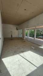 Bright unfinished room with sliding glass doors and tiled floors in Malibu Beach house Nueva Gorgona