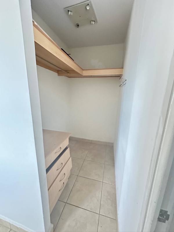 Closet space with tile flooring and built-in wooden shelving PH Los Alpes Brisas del Golf