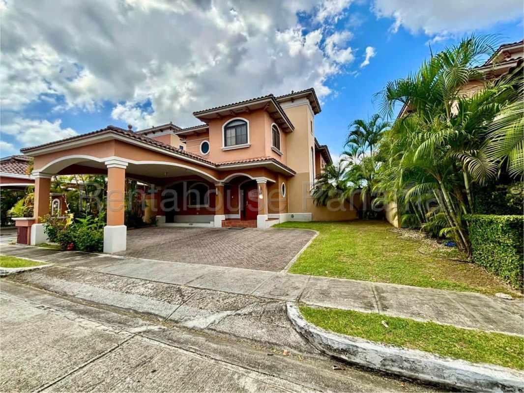 Modern living room with large windows, sectional sofa, tiled floor in Costa Sur Panama luxury house